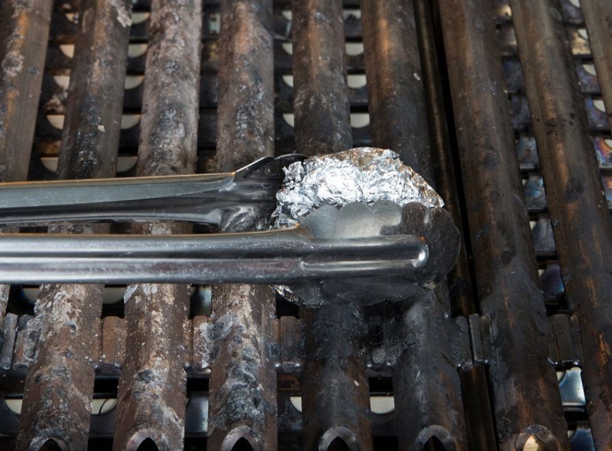 Scrunched up aluminium foil is good for cleaning a BBQ grill.