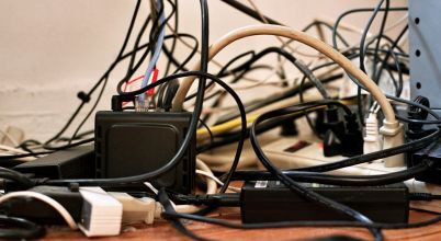 A mass of cables connected to a TV needs a cable management system or cable ties for safety and aesthetics.