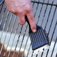 A BBQ wire brush will get in and around the grill grates to get the grime off.