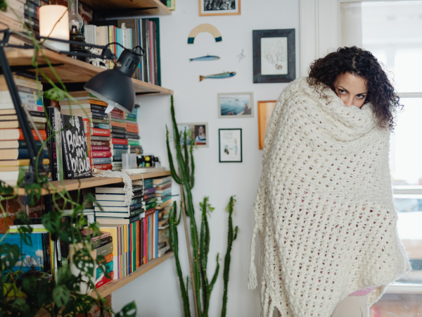 Wearing layers of clothing traps and warms air between layers to increase heat retention.