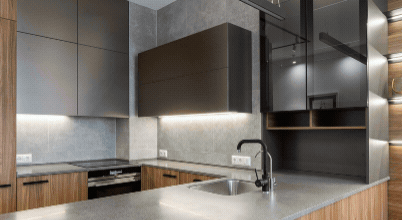 Under-cabinet lighting and bright, reflective surfaces in small, compact kitchens