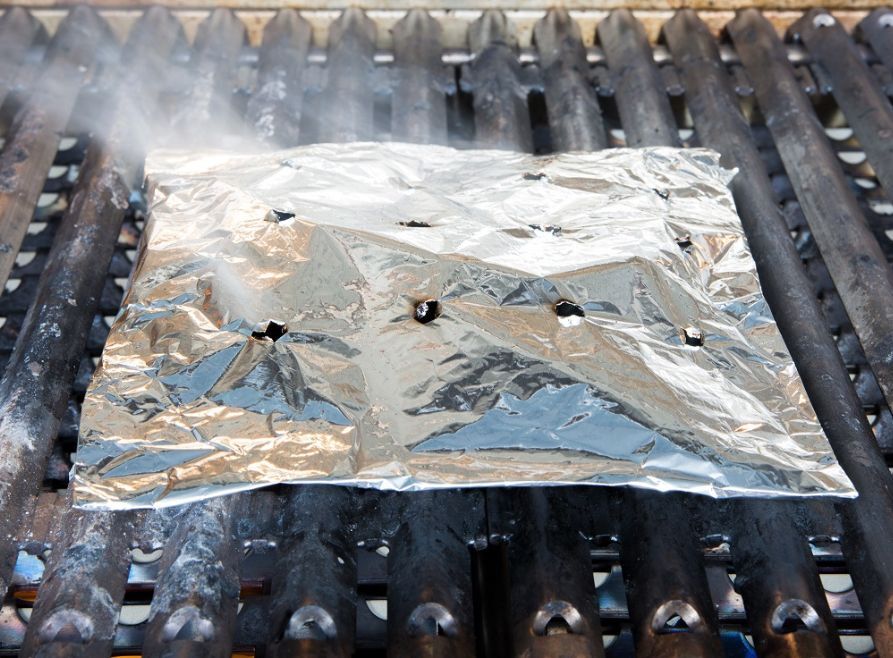 Placing woodchips inside an aluminium foil pouch can work as a homemade smoker to infuse BBQ with a smoky flavour